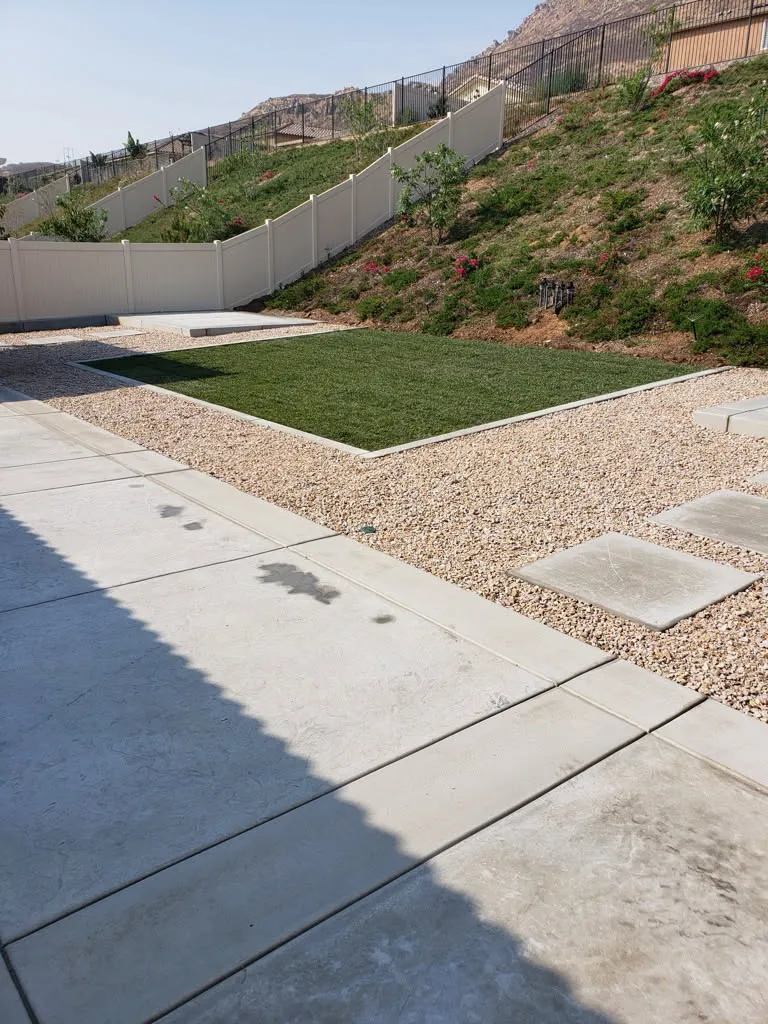 New concrete walkway along a landscaped side yard